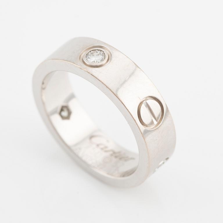Cartier "Love" ring in 18K white gold with three round brilliant-cut diamonds.