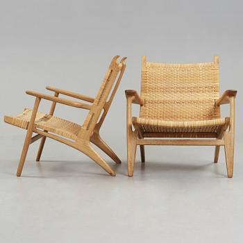 A pair of Hans J Wegner oak and rattan easy chairs 'CH-27', Carl Hansen & Son, Denmark.