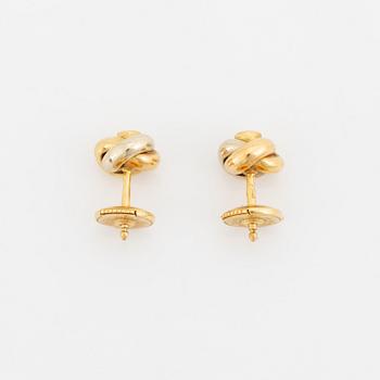 A pair of 18K gold Cartier "Trinity" earrings set with round brilliant-cut diamonds.