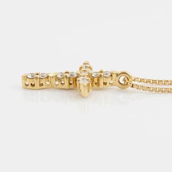 A pendant/cross 18K gold with round brilliant-cut diamonds.