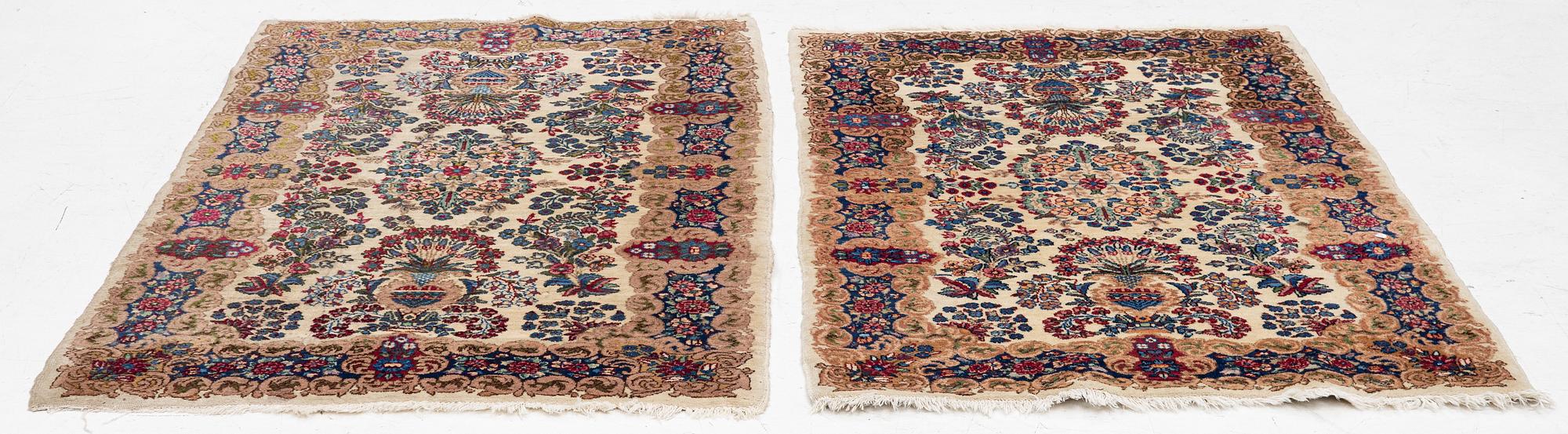 A pair of similar Kirman rugs, south Persia, c. 147 x 94 and 154 x 96 cm.