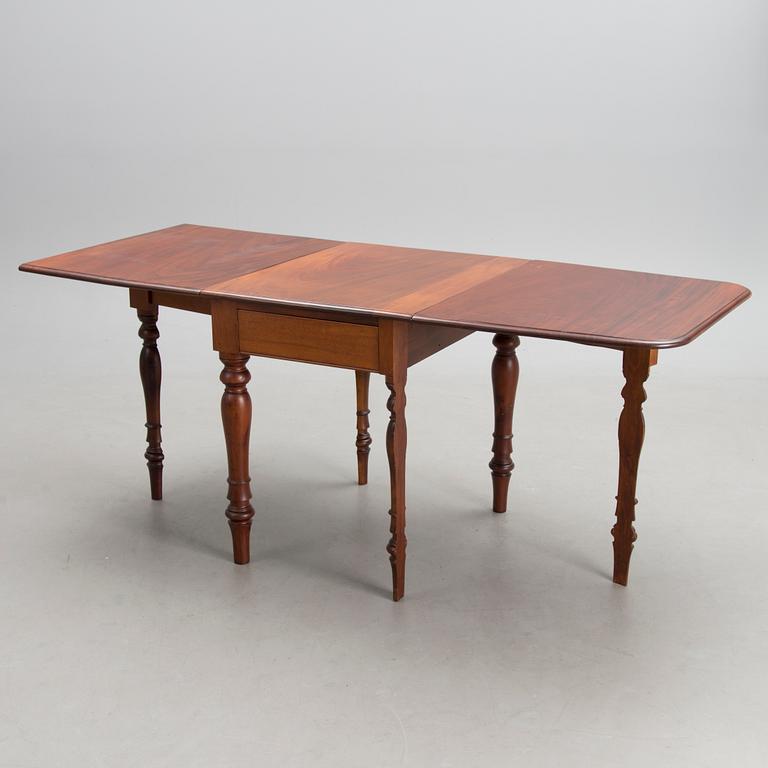 A 19th-20th Century drop leaf table.