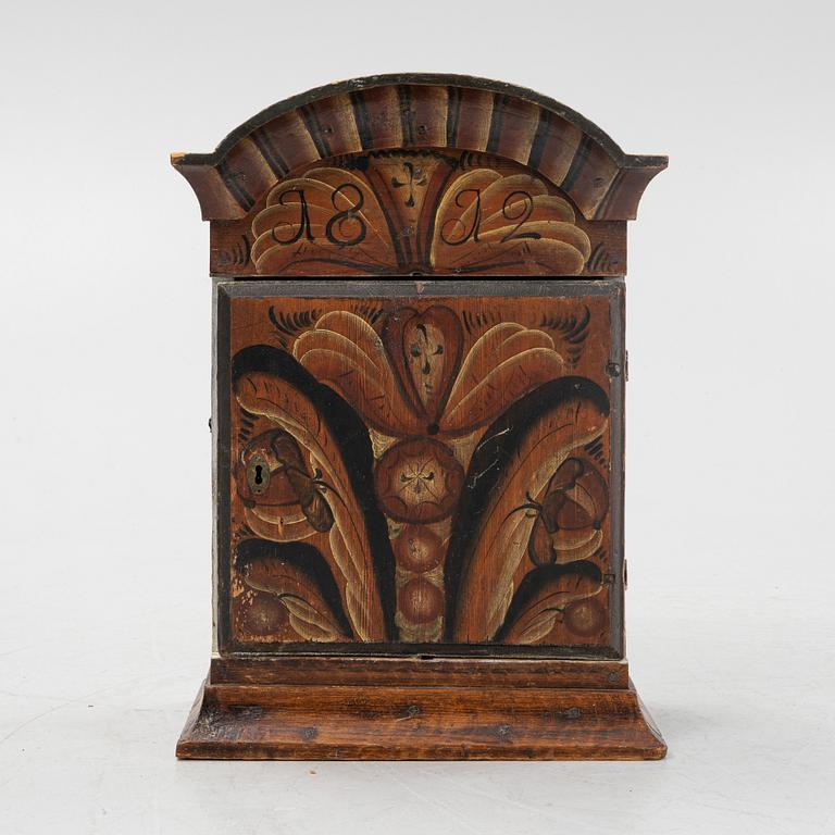 A pianted wall cabinet, dated 1812..