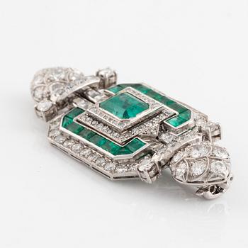 An 18K white gold Marchak art deco brooch set with step-cut emeralds.