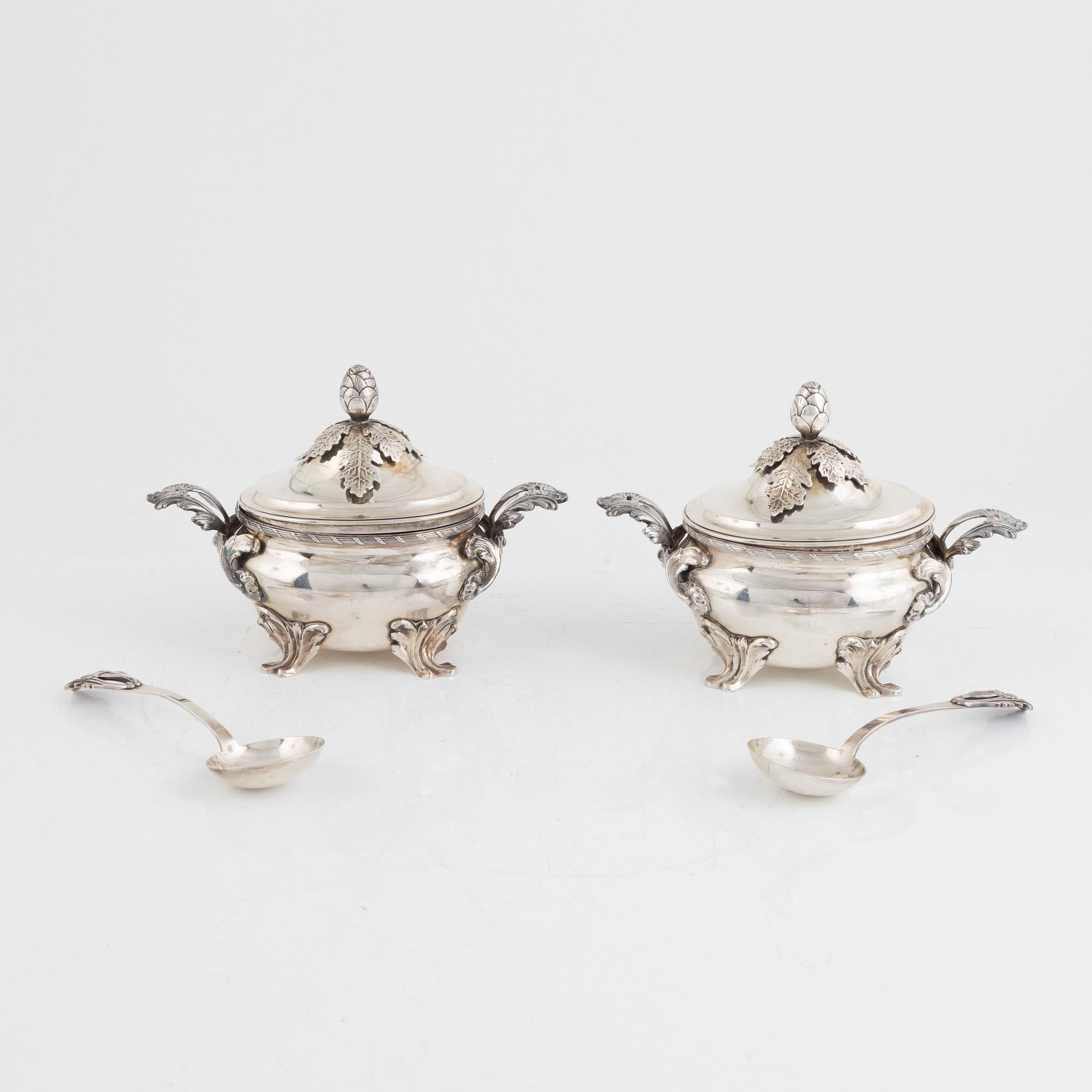 A pair of Swedish Rococo style sterling silver sauce tureens with lid and spoons, mark of Wiwen Nilsson, Lund 1947-1948.