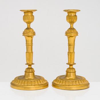 A pair of mid-19th-century gilded bronze candlesticks.