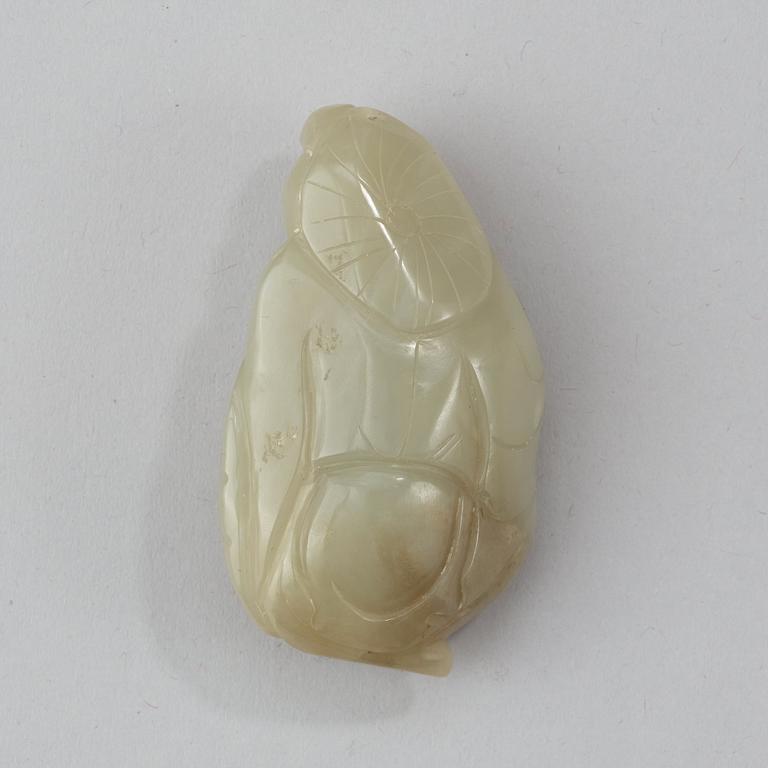 A Chinese nephrite figure of a immortal holding a fish.