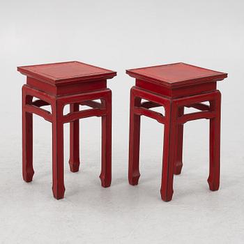 A pair of red Chinese small tables, 20th century.
