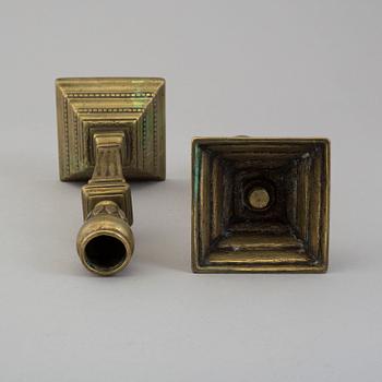 A pair of late 18th century bronze candlesticks.