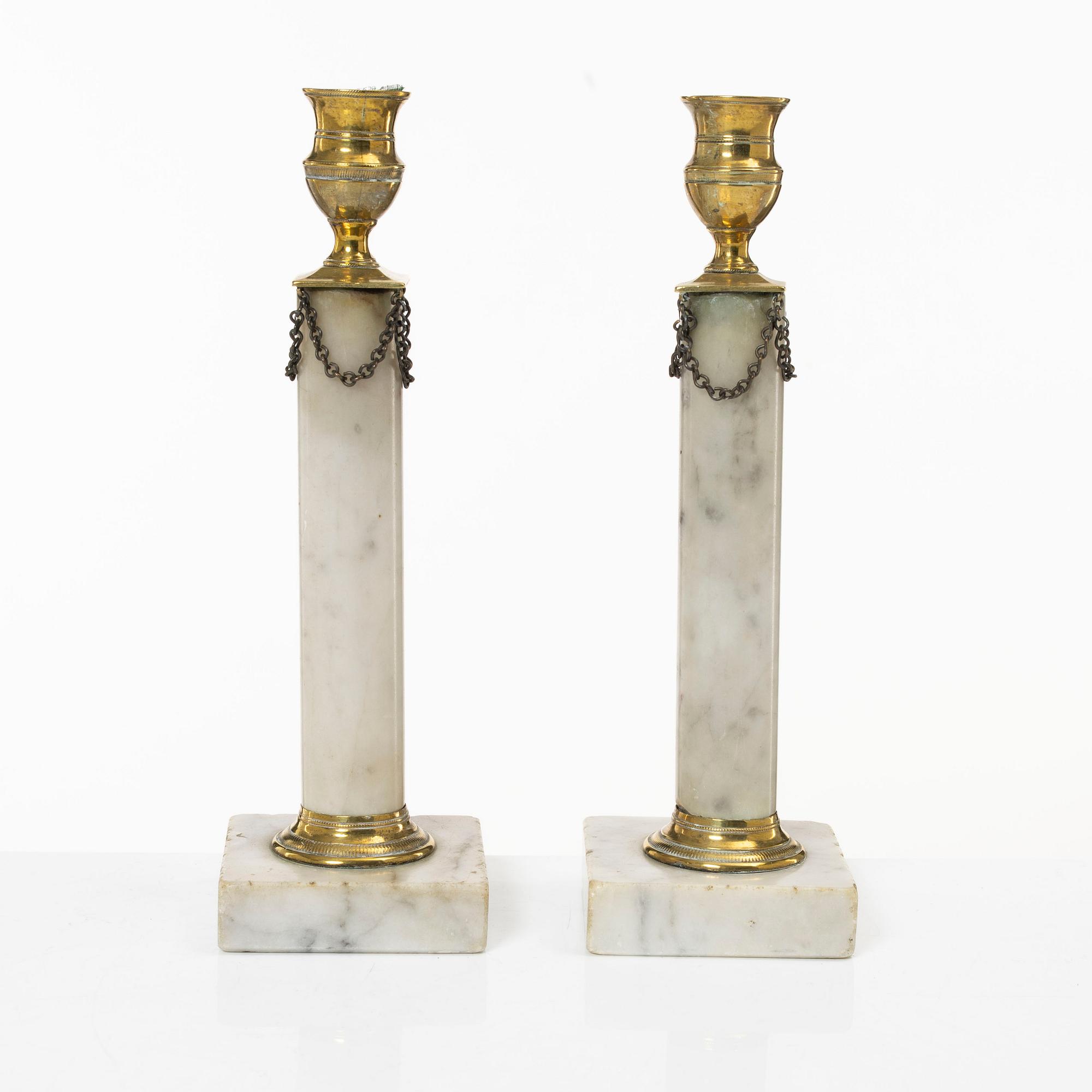 A pair of Gustavian brass and marble candlesticks, circa 1800.