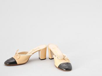 A pair beige and black leather slip-in by Chanel.