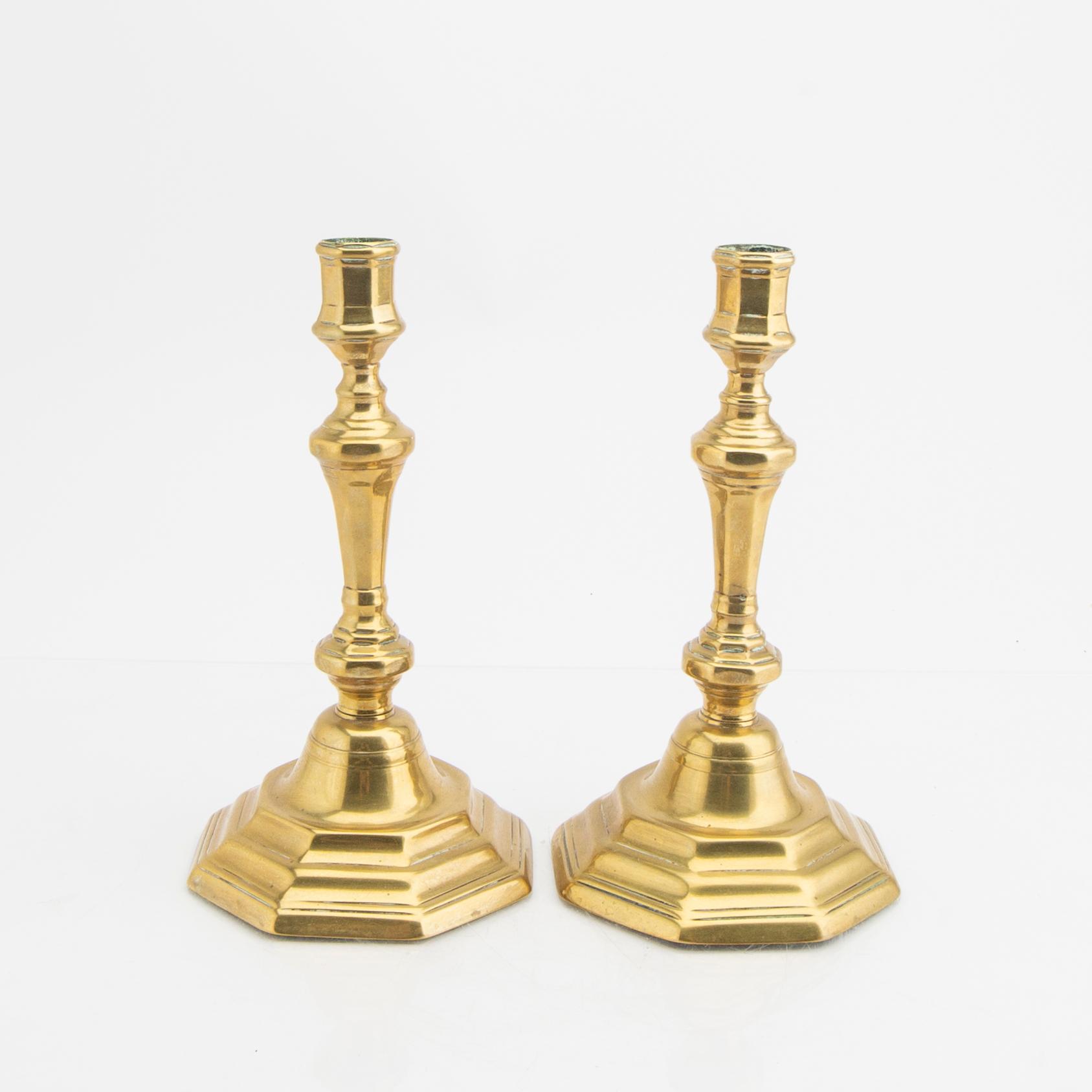 A pair of 18th century brass candle sticks.
