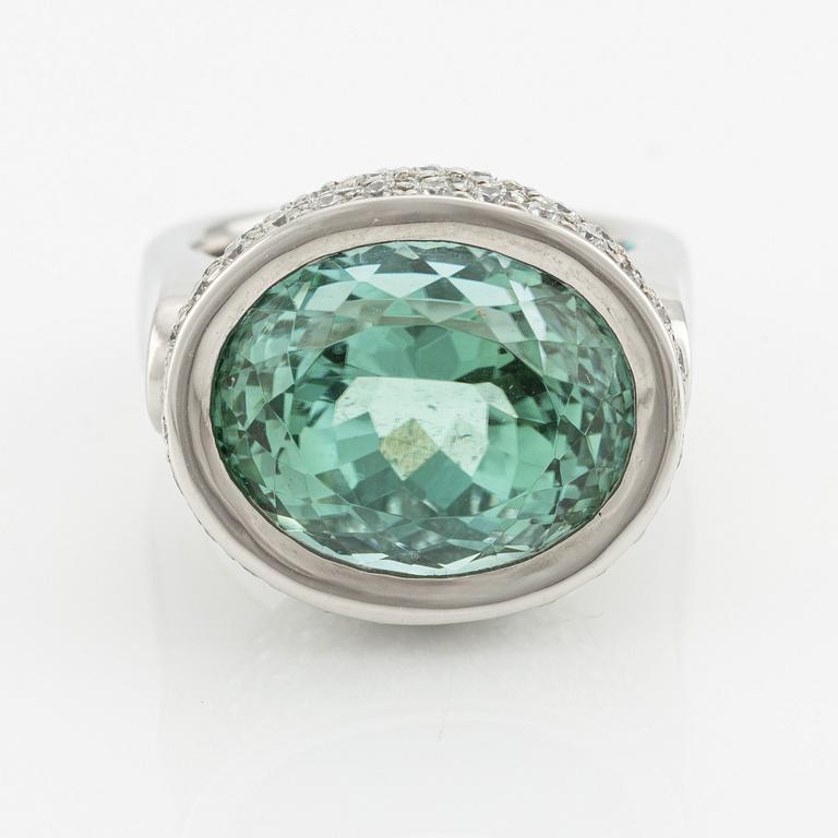 A Gaudy platinum ring with a faceted tourmaline and round brilliant-cut diamonds.