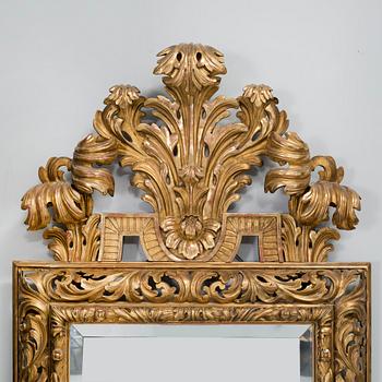 A baroque style mirror, around the year 1900.