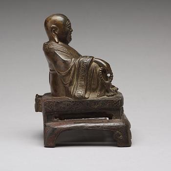 A setated bronze figure of Buddai, Qing dynasty (1664-1912).