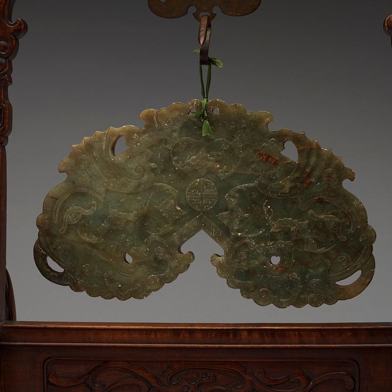A pale spinach nephrite chime-stone with wooden stand, Qing dynasty, presumably 19th Century.