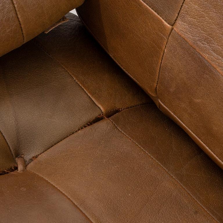 A pair of 1970/80:s easy chairs with stools.