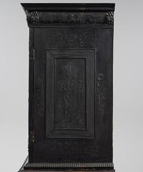 A Louis XIV and Louis XIV-style carved ebony, ivory and tortoiseshell-inlaid cabinet on stand, 17th and 19th century.