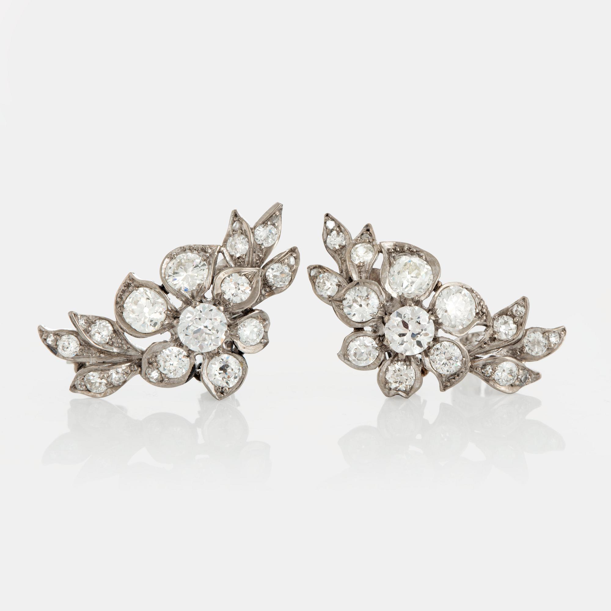 A pair of earrings set with old-cut diamonds.