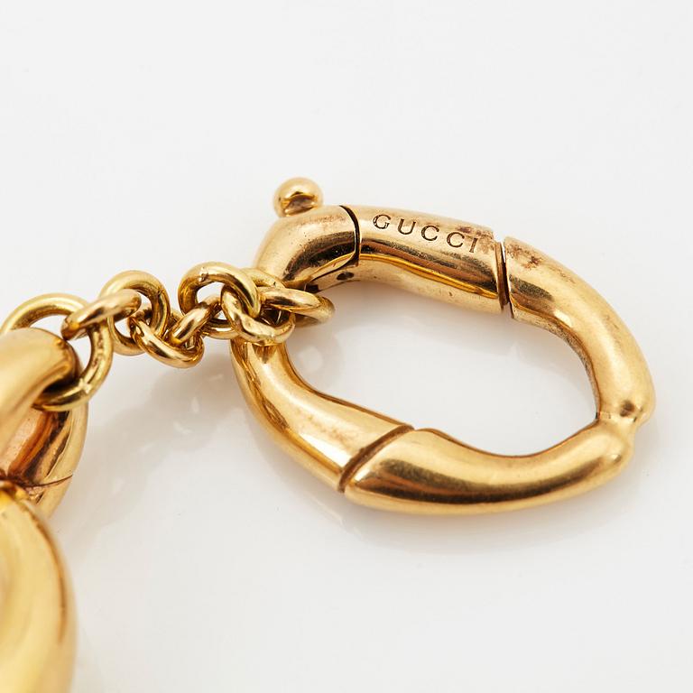 An 18K gold Gucci bracelet.