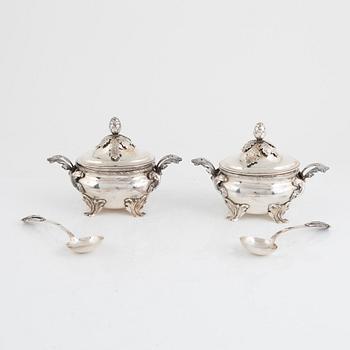 A pair of Swedish Rococo style sterling silver sauce tureens with lid and spoons, mark of Wiwen Nilsson, Lund 1947-1948.