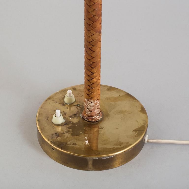 A brass and leather table light from Nordiska Kompaniet, mid 20th Century.