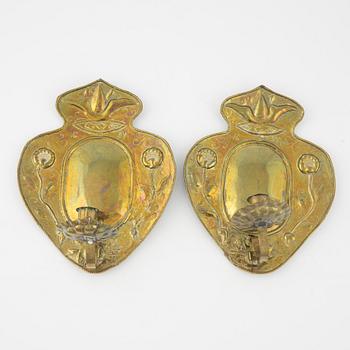 A pair of Baroque repoussé brass one-light sconces, first part of the 18th Century.