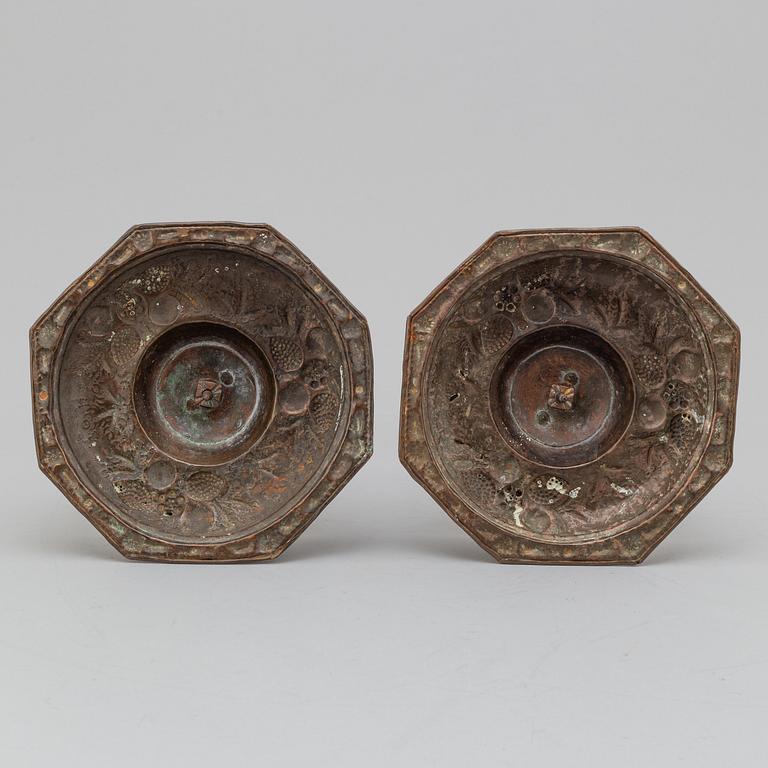 A pair of possibly 17th century brass candlesticks.