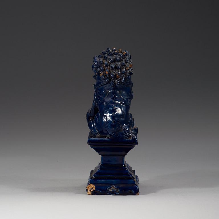 A seated blue glazed buddhist lion, Ming dynasty, 17th Century.