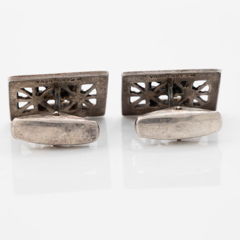 Four silver jewellery pieces: three brooches and a pair of cufflinks. With rose quartz and tiger’s eye. Finnish designers.