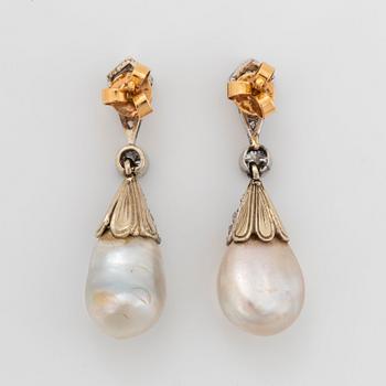 A pair of platinum and 18K gold pearl earrings set with old-cut diamonds.