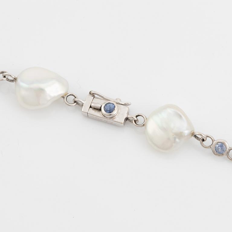 A Seaman Schepps 18K gold and cultured fresh water pearl necklace set with sapphires.