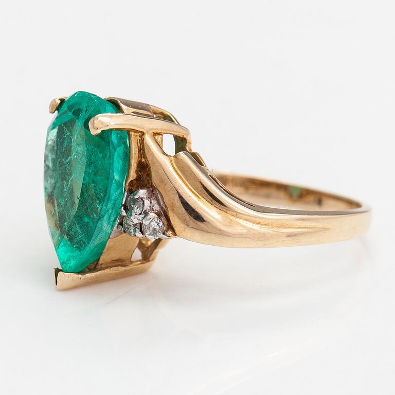 Ring, ca 10-11K gold with a pear shaped emerald and diamonds approx 0.10 ct in total.