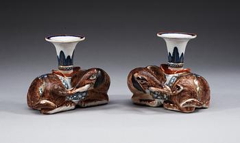 A pair of famille rose candlesticks in the shape of elephants, Qing dynasty, Qianlong (1736-95).