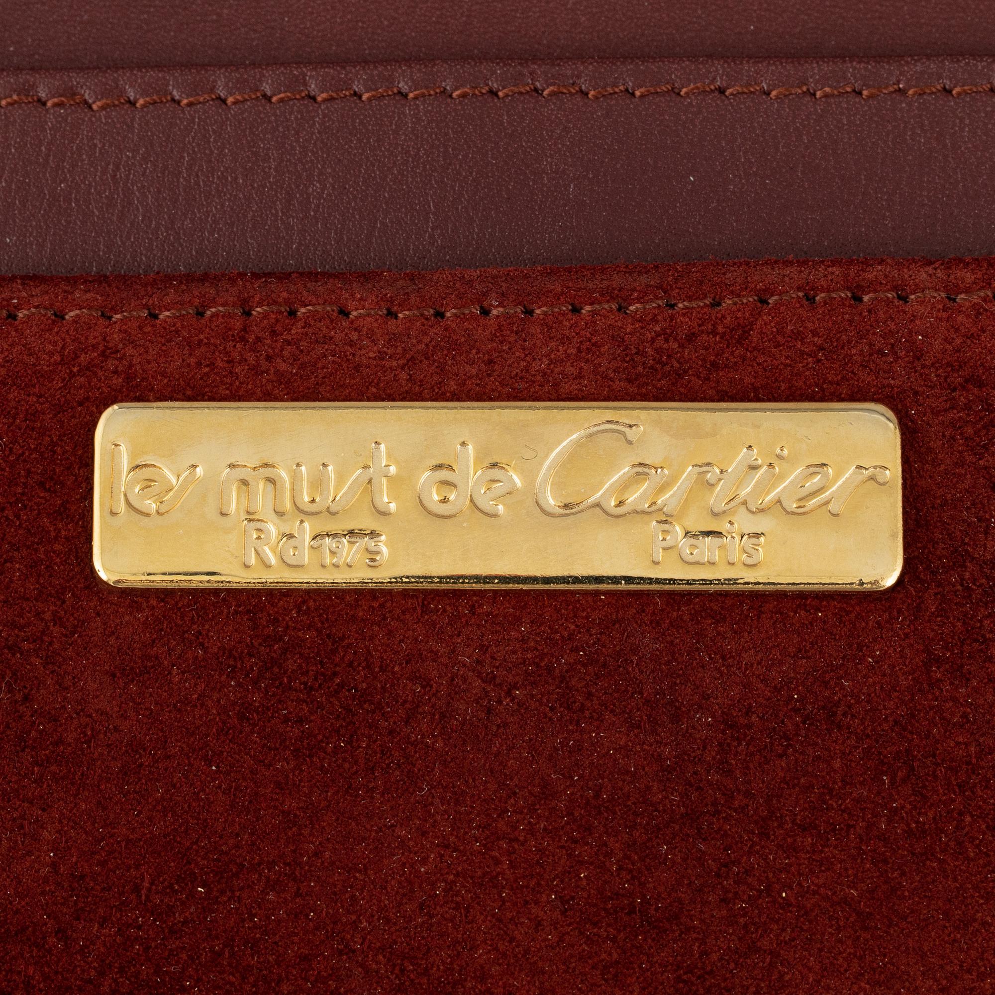 Cartier, a red suede clutch.