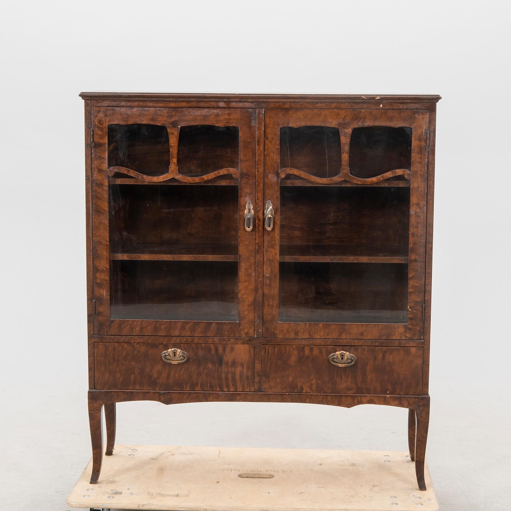 A 1920s  stained beech display cabinet.