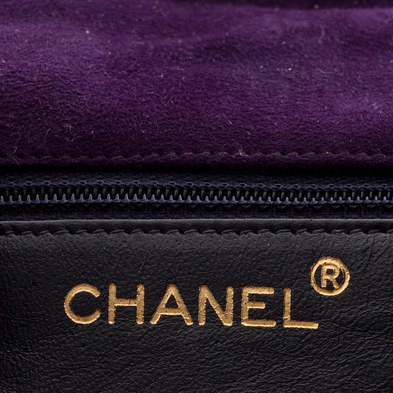 CHANEL, a purple suede evening bag.