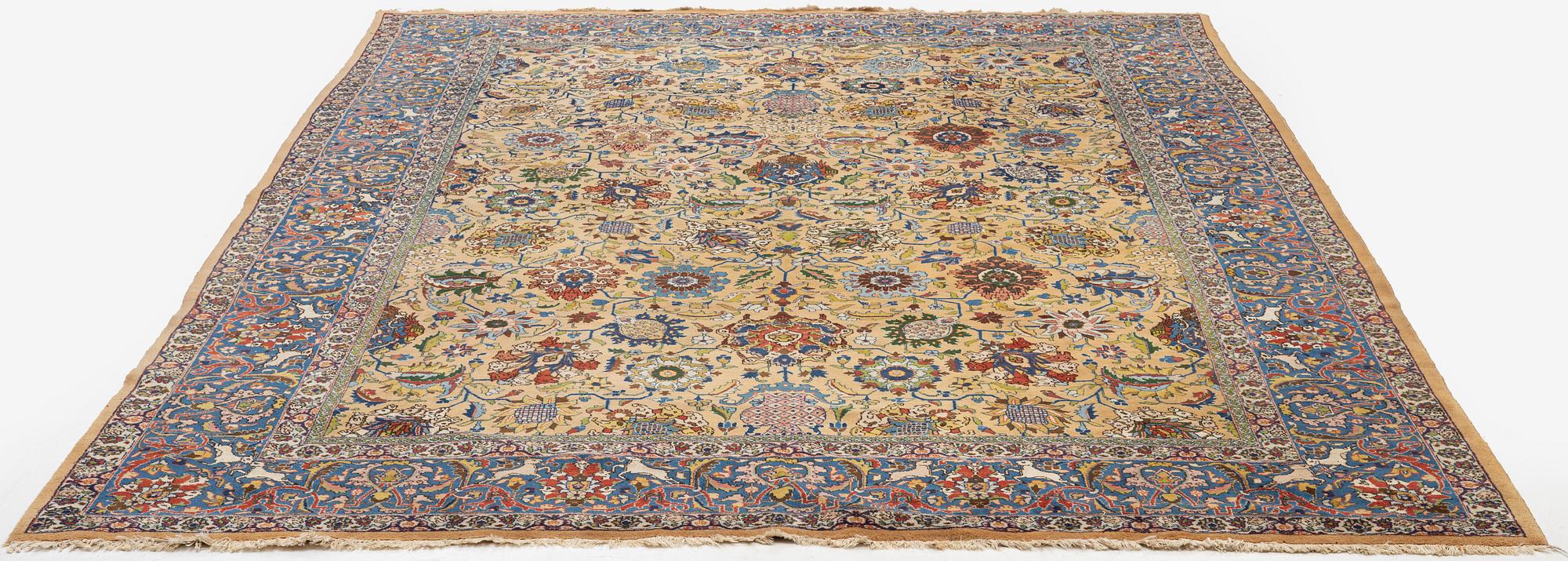 A semi-antique Tabriz carpet of vase design, West Persia, c. 404 x 292 cm.