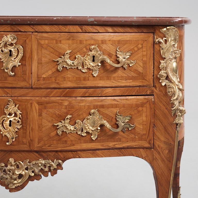 A Louis XV kingwood parquetry and ormolu-mounted commode in the manner of Jacques-Philippe Carel (Paris, 1723-1760).