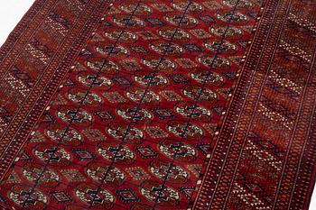 An oriental rug, c. 184 (+4cm flat weave on each end) x 133 cm.