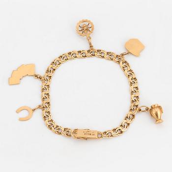 An 18K gold charm bracelet.