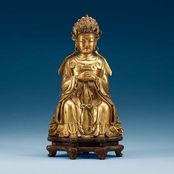 1389. A gilt bronze figure of a sitting female deity, Qing dynasty, 18th Century.