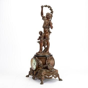 A metal table clock around 1900.