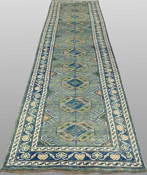 An Oriental runner, c. 393 x 79 cm.