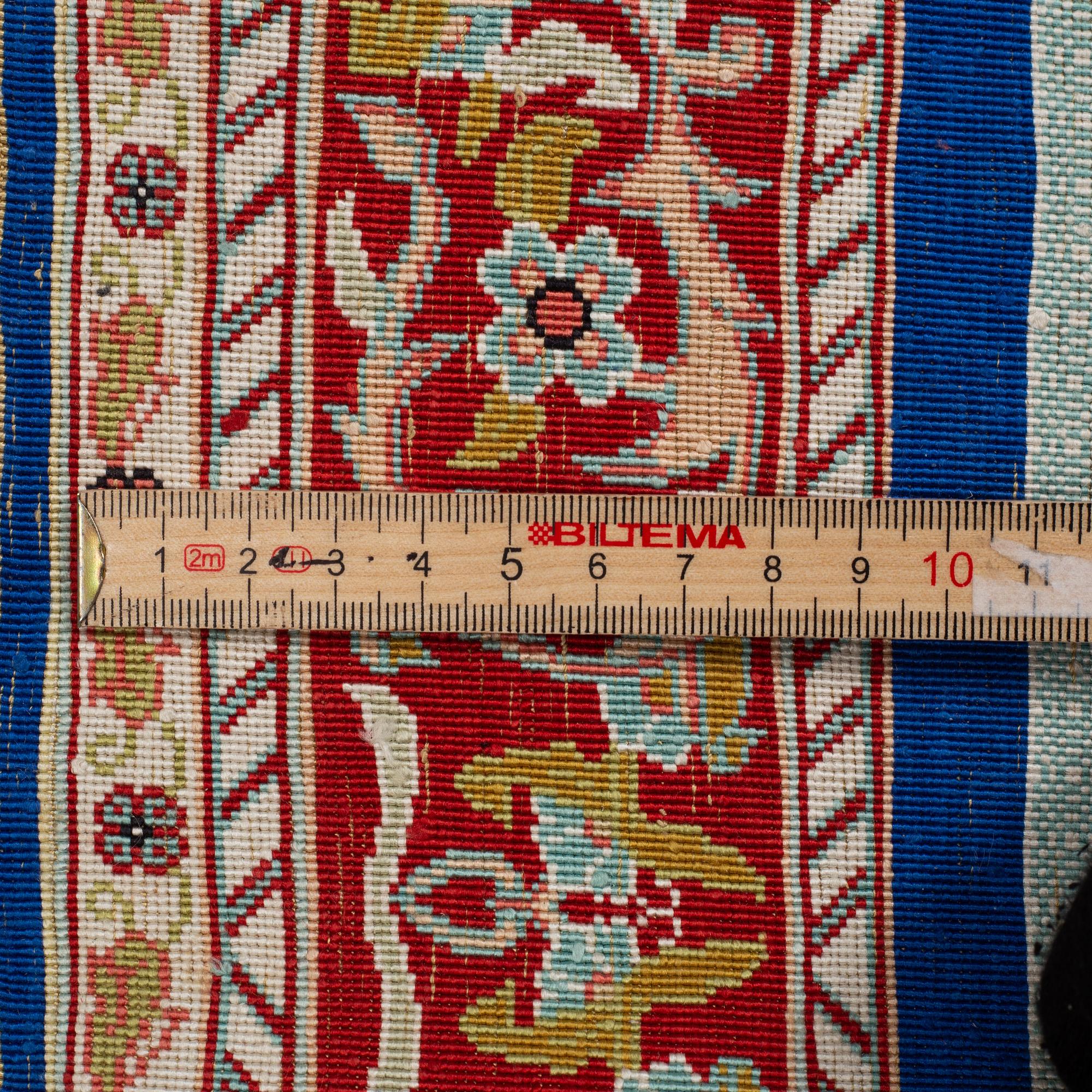 A rug, silk Hereke, ca 143 x 63,5 cm.
