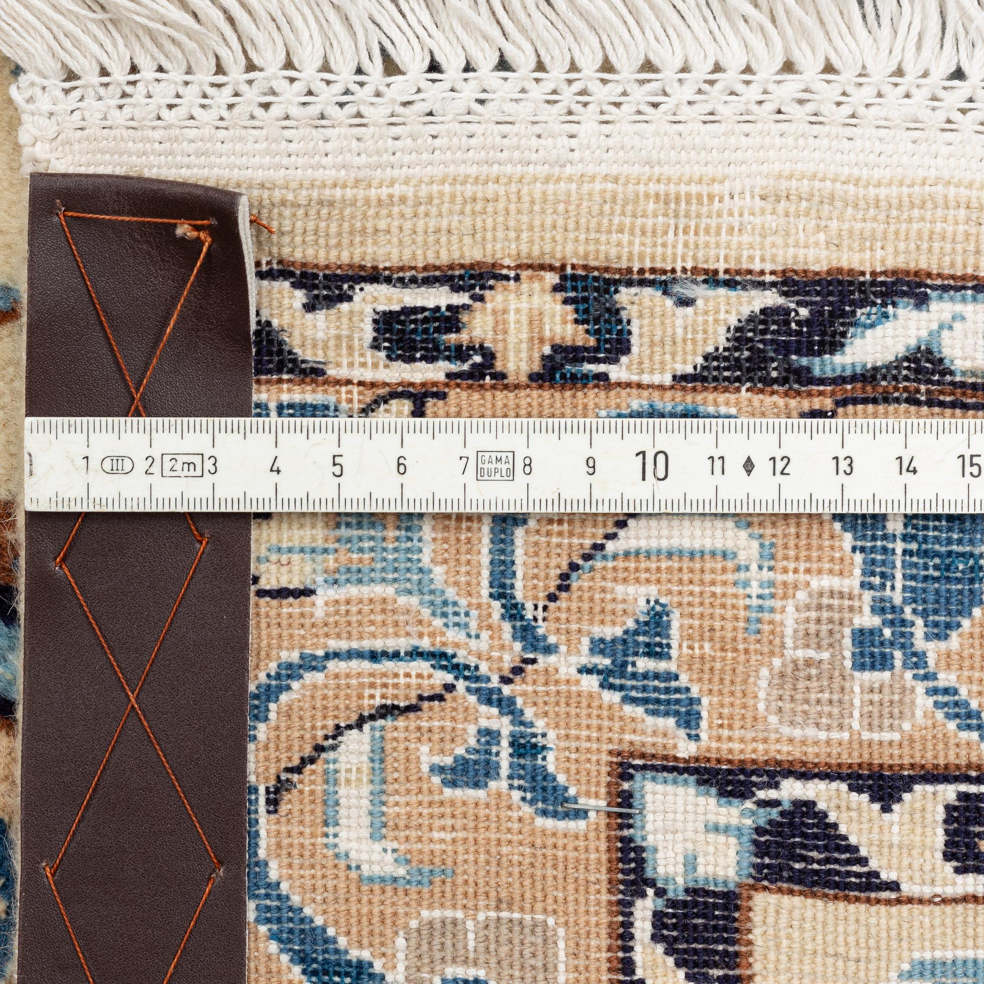 A carpet, Nain, part silk, fine 9 laa, signed, ca 327 x 210 cm.