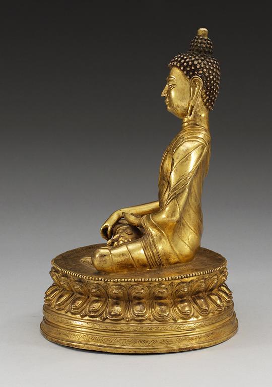 A gilt bonze sinotibethan figure of a seated Buddha, 19th Century.