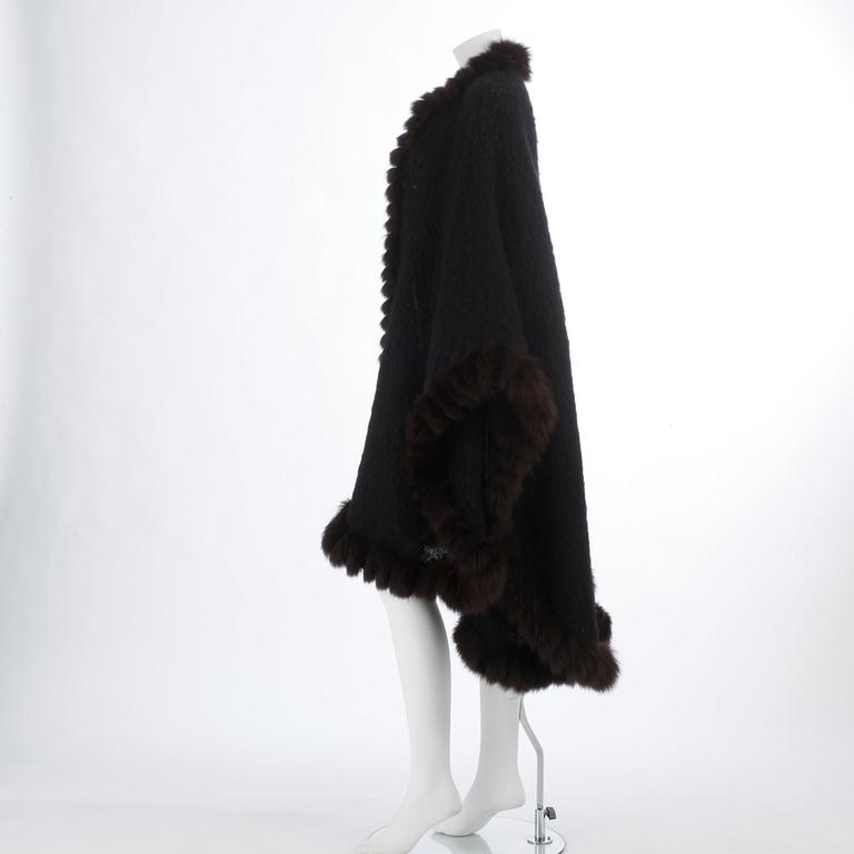 YVES SAINT LAURENT, a black wool and brown fur trimmed cape.