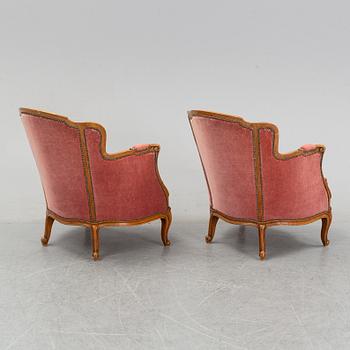 A pair of rococo style easy chairs from around the year 1900.