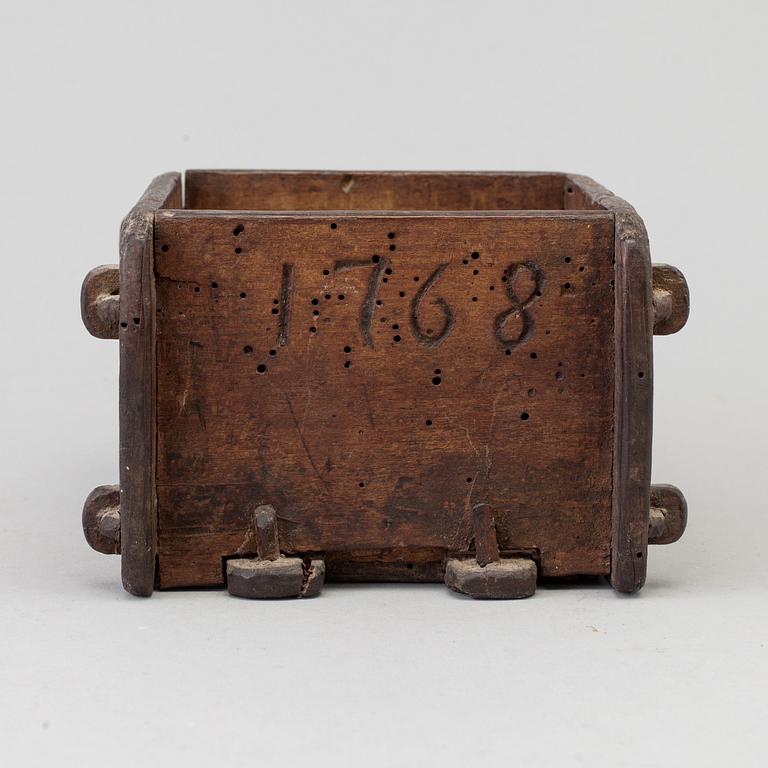 A cheese mould, dated 1768.